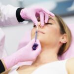 doctor-performing-rhinoplasty-by-injection-of-hyaluronic-acid-in-the-nose-of-his-patient-1.jpg